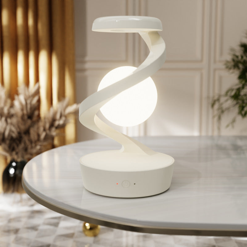 Lampe de chevet à sphère lumineuse, coloris blanc, sur une table