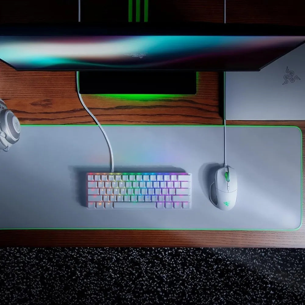 Image of Razer Goliathus Chroma Extended mouse pad with RGB setup, keyboard, and gaming mouse on a sleek desk.