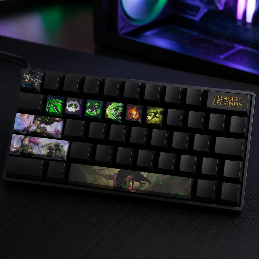 Akali keycaps fitted on a black mechanical keyboard in front of a gaming PC