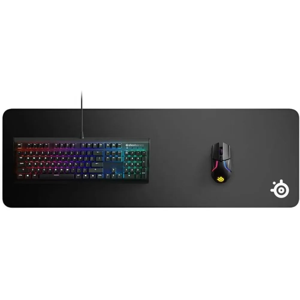 SteelSeries QcK Edge XL gaming mousepad with keyboard and mouse setup, featuring a sleek black design.