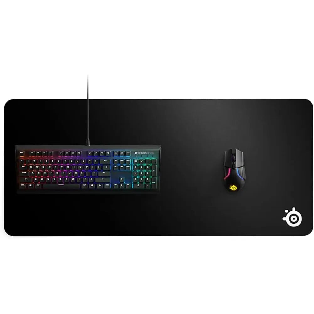 Image of SteelSeries QcK Heavy XXL gaming mouse pad with keyboard and mouse set up for optimal gaming performance.